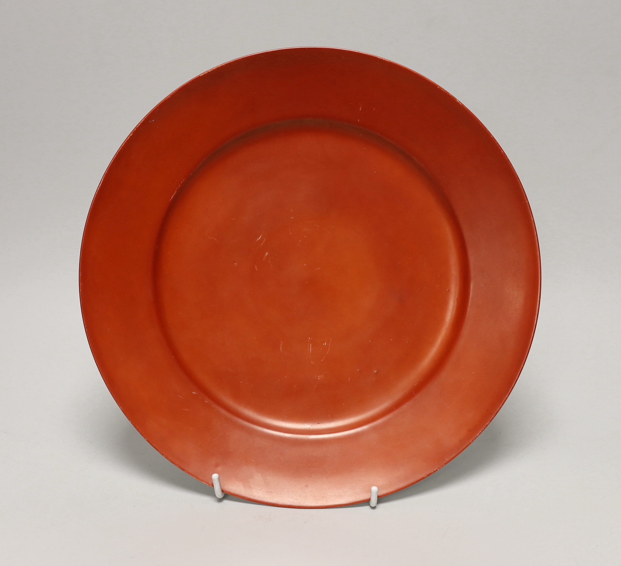 A Japanese red monochrome plate, a lidded cup hand painted with figures and flowers and floral teapot, the largest 27cm in diameter